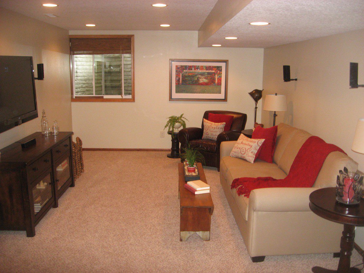 A small living room with light and dark brown furniture