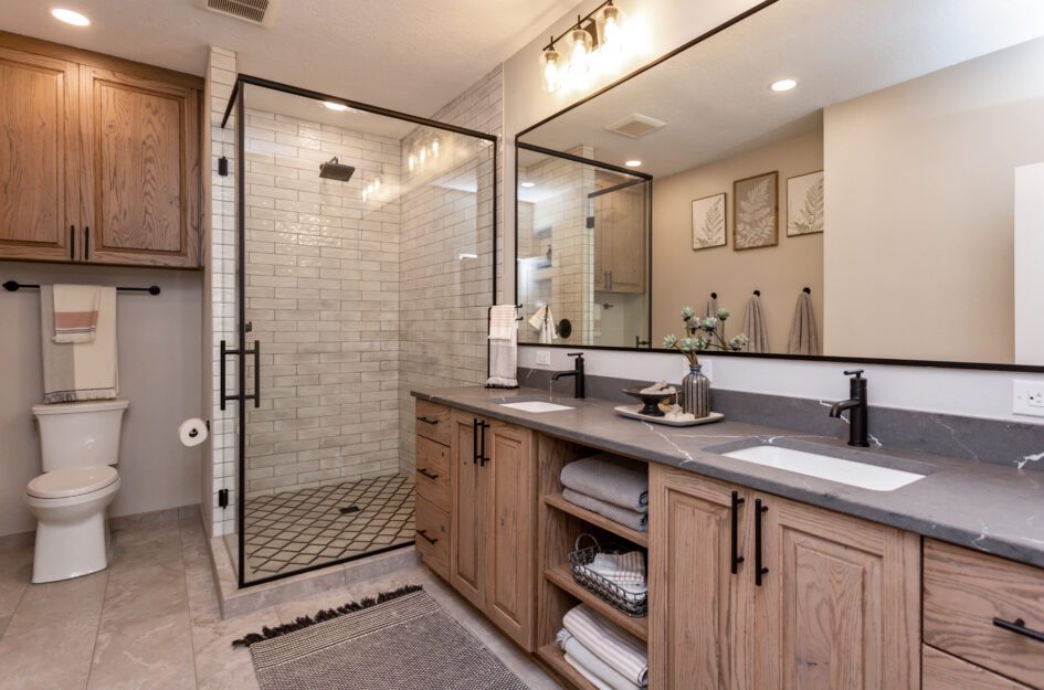 A wood themed bathroom with a shower area and a large mirror