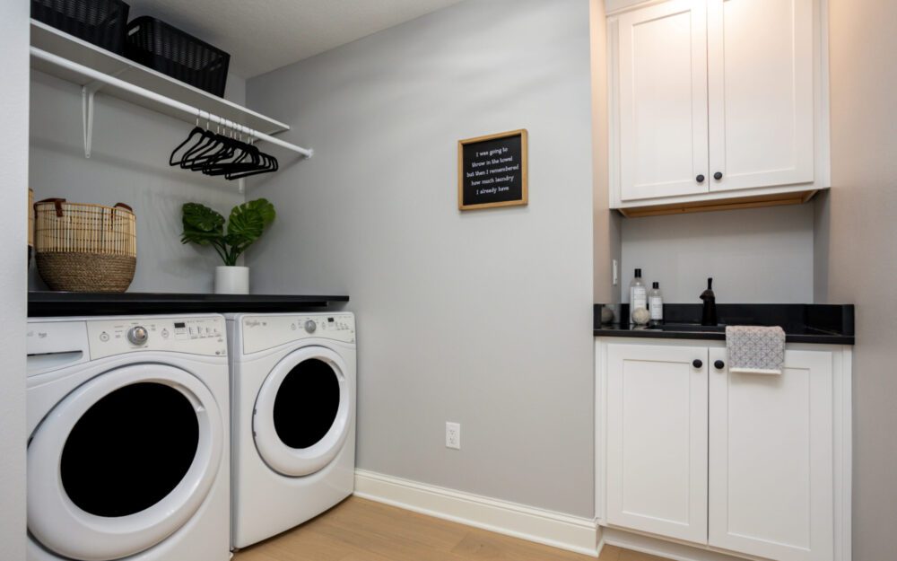 Laundry area with washer, dryer, and hangers