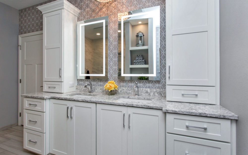 A white remodeled bathroom counterops and fixtures