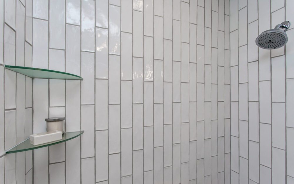 A shower fixture with glass shelving