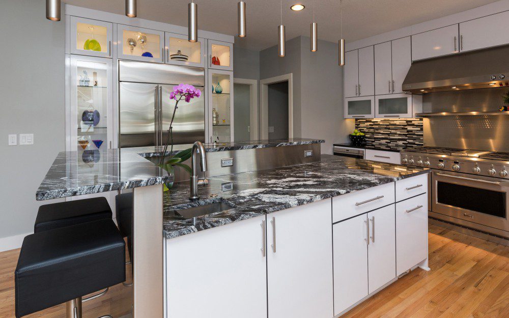 A kitchen with white and grey colors
