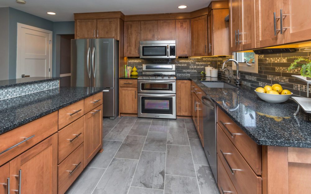 A kitchen with wood and granite designs