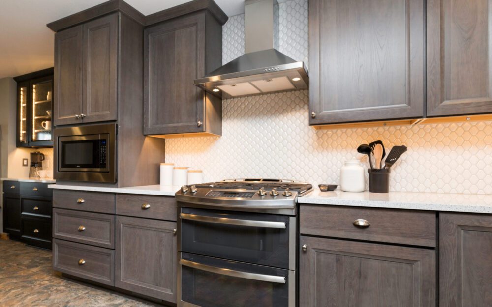 Brown cabinetry with white surfaces and a stove at the middle