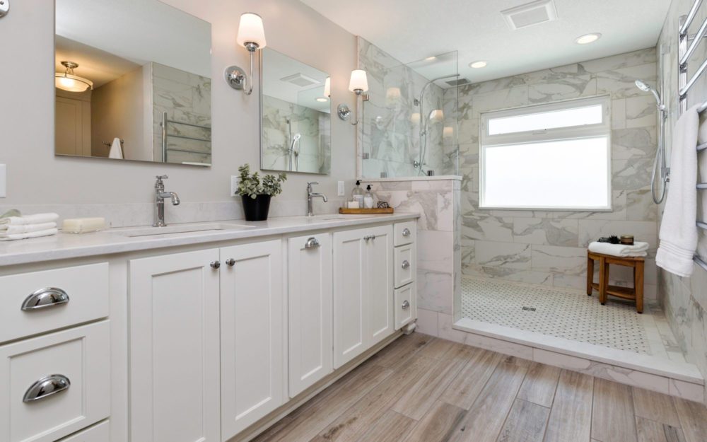 A white bathroom with a large shower area